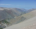 The Panamericana (just visible on the right) drops some 5,000 ft down from the Atacama Desert plateau to the fertile Quebrada de Camarones; you can just see the Pacific Ocean in the distance